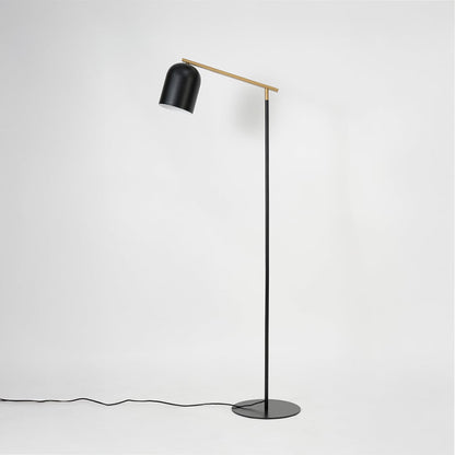 Detailed view of matte black dome lampshade on gold rod arm offering directional lighting for modern spaces
