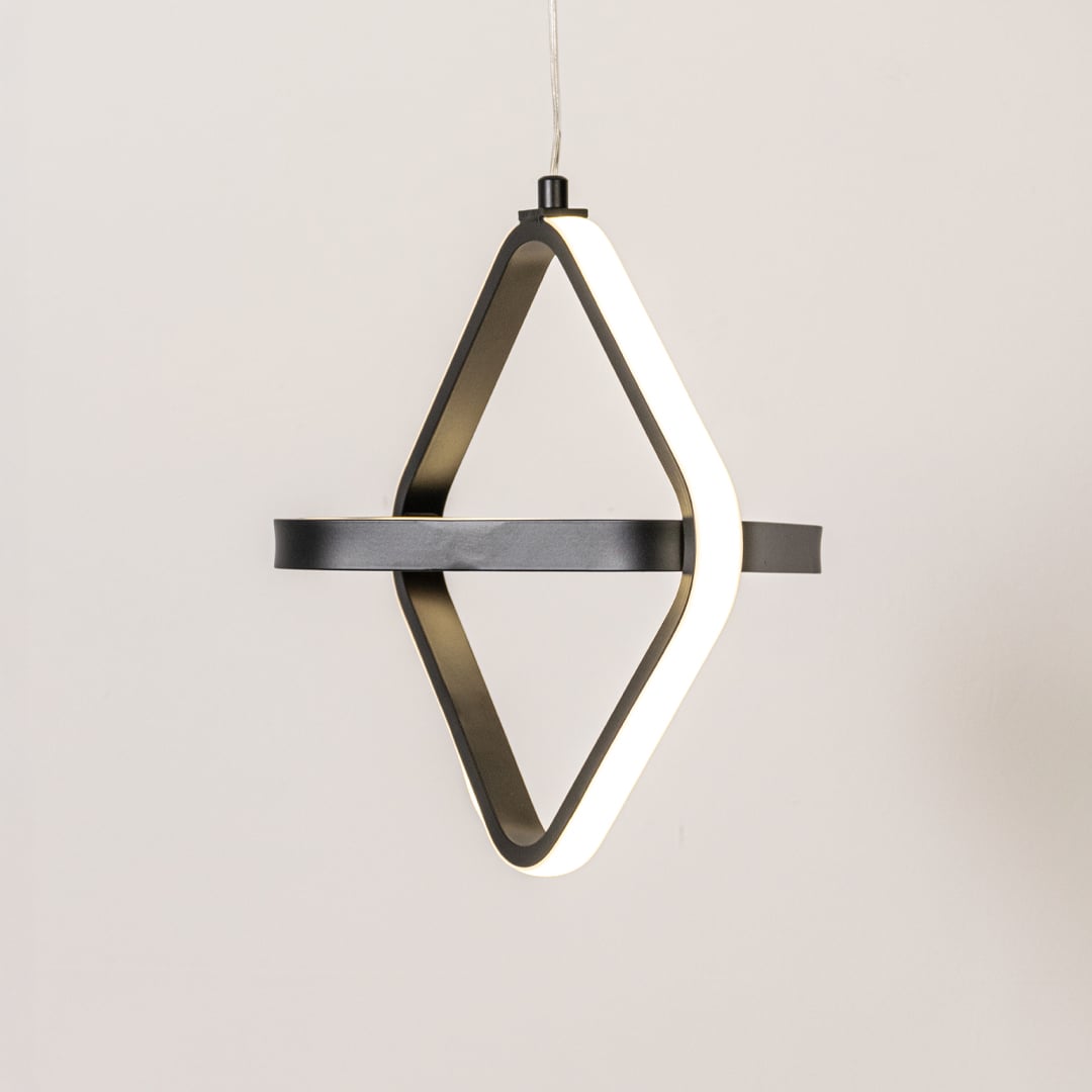 Black and white geometric LED pendant light glowing softly on white background for modern living room kitchen island decor.
