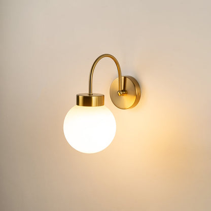 Modern gold metal wall light with white glass globe for elegant hallway and luxury decor styling spaces.