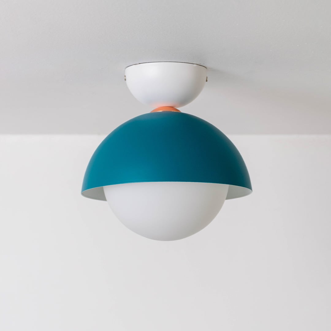 Ceiling light displayed off on a white background with a teal dome and white globe giving a clean modern style.