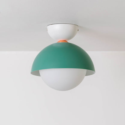 Ceiling light displayed off on a white background with a green dome shade and a simple round white globe.