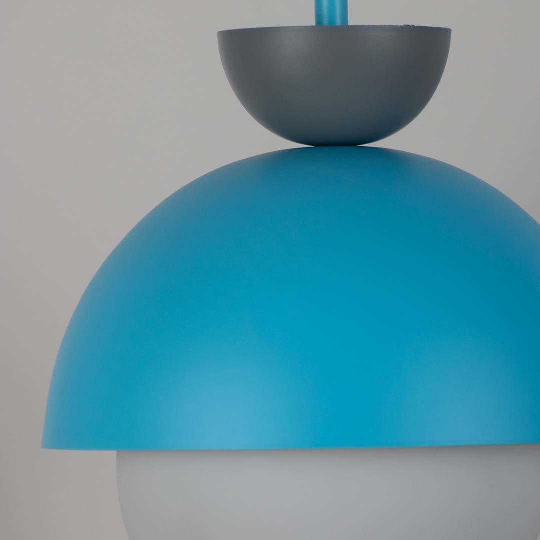Detailed view of blue metal pendant light with white glass diffuser highlighting premium design.