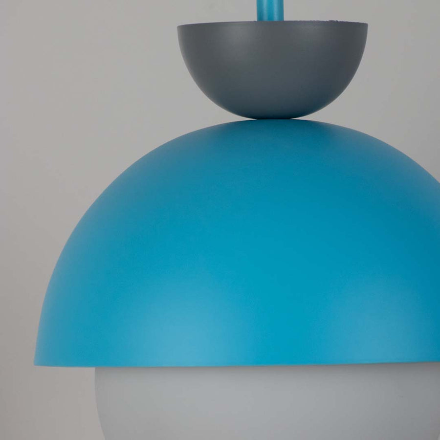 Detailed view of blue metal pendant light with white glass diffuser highlighting premium design.
