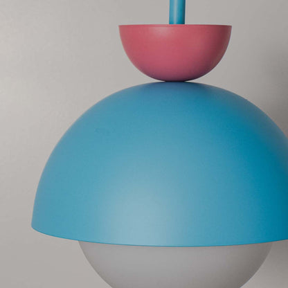 Closeup of blue metal pendant light with pink accents showcasing refined craftsmanship and finish.