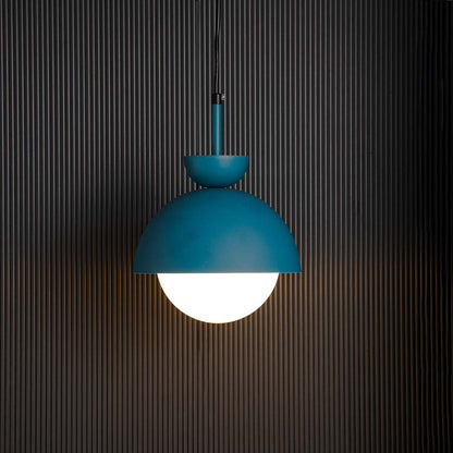 Blue dome pendant ceiling light with frosted white globe glowing warmly against black background creating stylish home interior.
