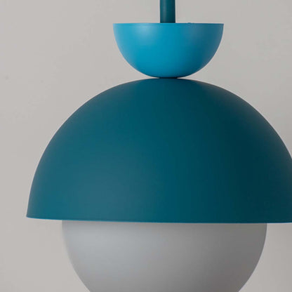 Close up of teal metal pendant light with smooth dome shade and glass globe diffuser against neutral background for premium ceiling lighting design.


