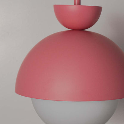 Stylish matte pink pendant lamp with smooth metal finish and frosted glass globe shade ideal for bedroom and dining lighting.