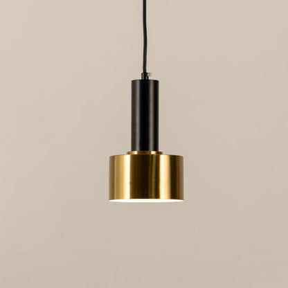 Gold and black metal pendant light with bulb switched on shown against a clean white background highlighting its modern minimal design.