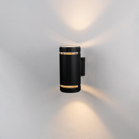 Black metal outdoor wall light on white background with gold accent bands for elegant patio lighting decor.