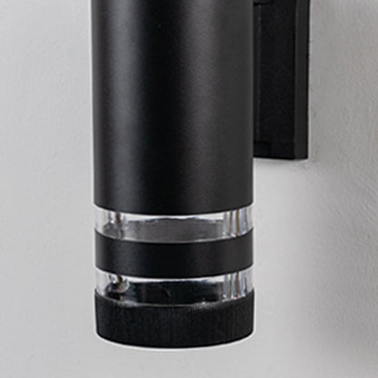 Closeup view of black cylindrical wall light showcasing its matte finish and polished acrylic detailing.