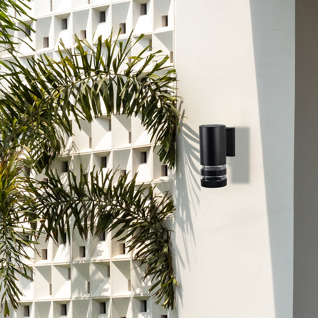 Stylish black cylindrical wall light enhancing modern home exteriors with warm ambient glow and sleek elegance.