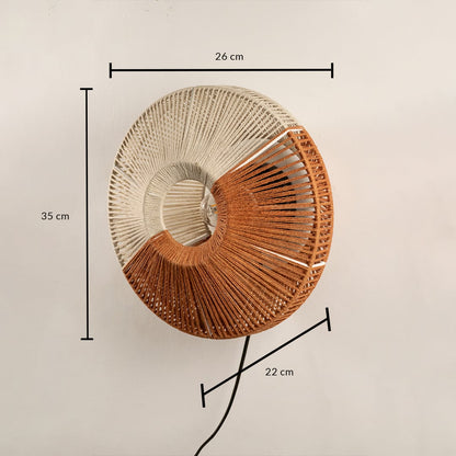 Round woven wall lamp in natural and warm tones shown with size of 60 cm width and 50 cm height adding a handcrafted textured accent to the interior.