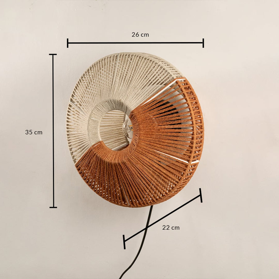 Round woven wall lamp in natural and warm tones shown with size of 60 cm width and 50 cm height adding a handcrafted textured accent to the interior.