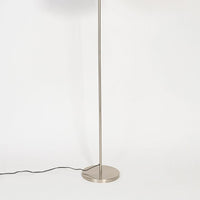Minimal floor lamp with brushed silver metal stem and circular base shown on white background for clean modern interior styling.