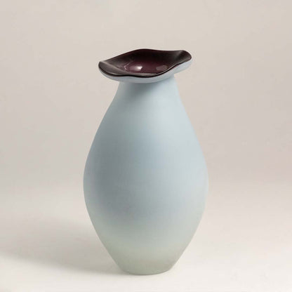 White ceramic decorative vase with maroon rim and organic silhouette for modern shelf styling and home decor.
