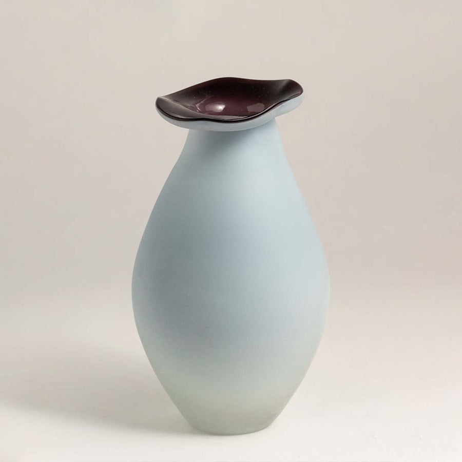 White ceramic decorative vase with maroon rim and organic silhouette for modern shelf styling and home decor.