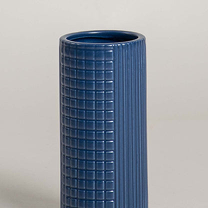 Closeup of blue ceramic decorative vase with textured grid design highlighting premium craftsmanship and modern decor.