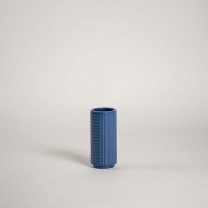 Modern blue textured ceramic vase shown on a plain white background ideal for home shelves console tables and minimal styling.