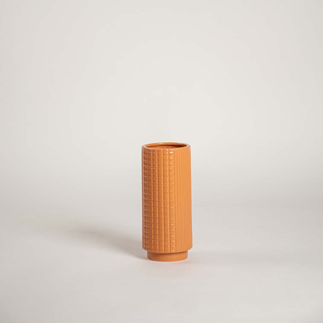 Modern terracotta textured ceramic vase placed on a plain white background ideal for shelves consoles and stylish home accents.