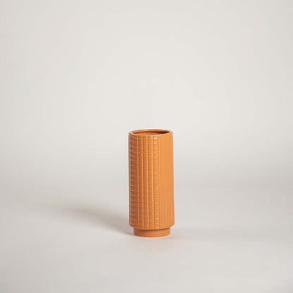 Modern terracotta textured ceramic vase placed on a plain white background ideal for shelves consoles and stylish home accents.