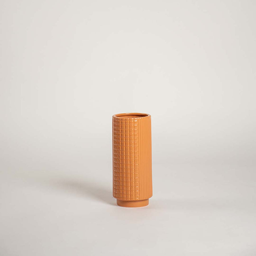 Modern terracotta textured ceramic vase placed on a plain white background ideal for shelves consoles and stylish home accents.