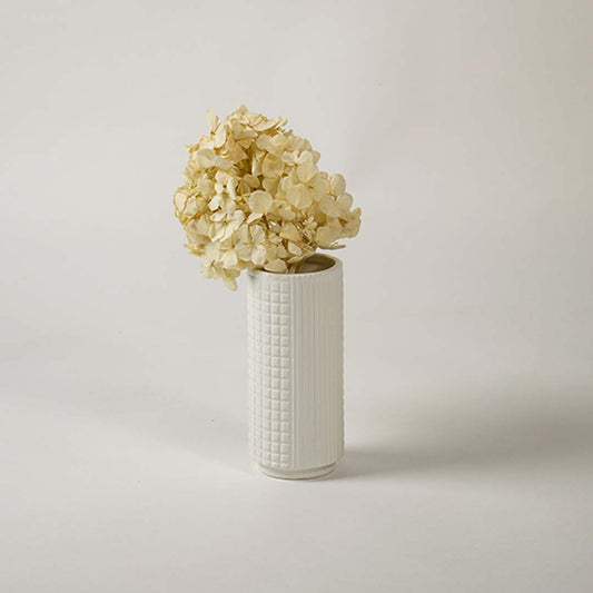 Tall white ceramic textured vase styled in a modern interior setting ideal for living room or hallway decor.