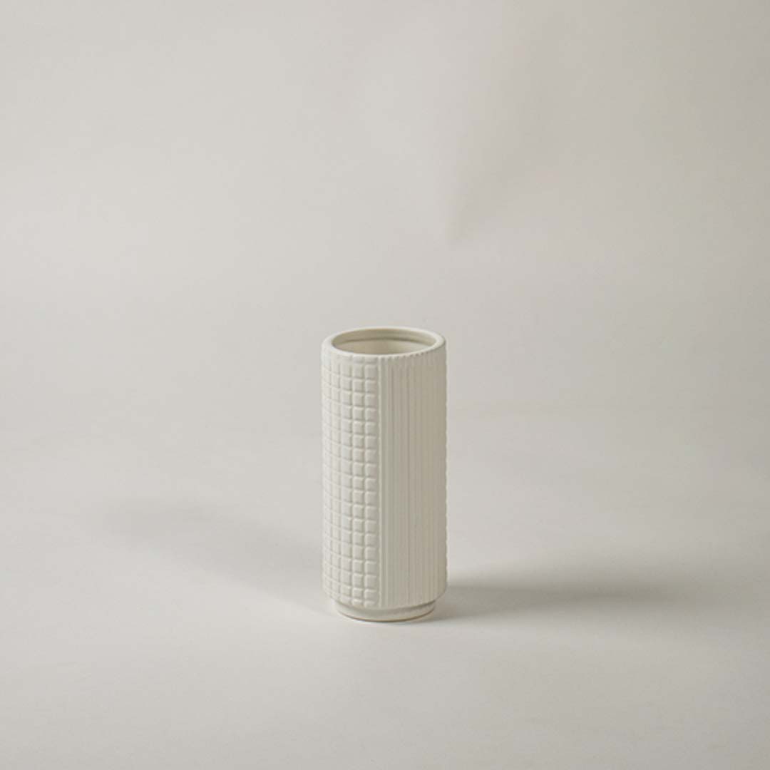 Textured white ceramic vase displayed on clean white background ideal for modern shelf and tabletop decor.