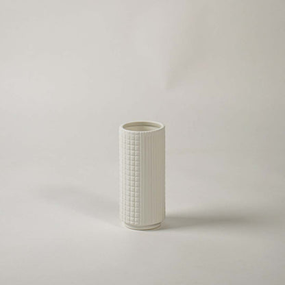 Textured white ceramic vase displayed on clean white background ideal for modern shelf and tabletop decor.