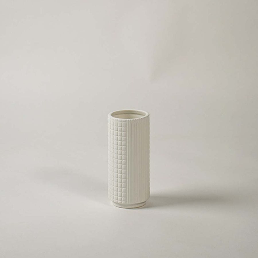 Textured white ceramic vase displayed on clean white background ideal for modern shelf and tabletop decor.