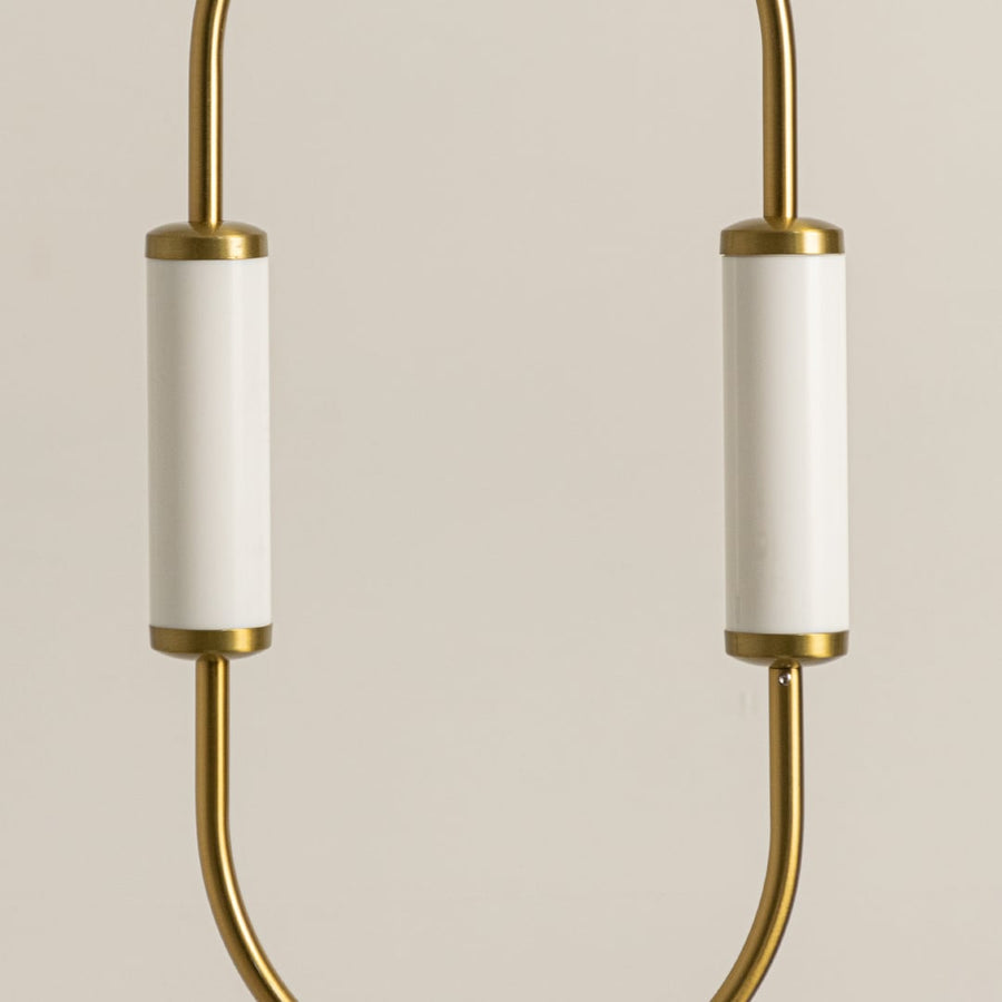 Close up view of brass gold pendant light fixture showing white glass shades and metal frame craftsmanship detail work.
