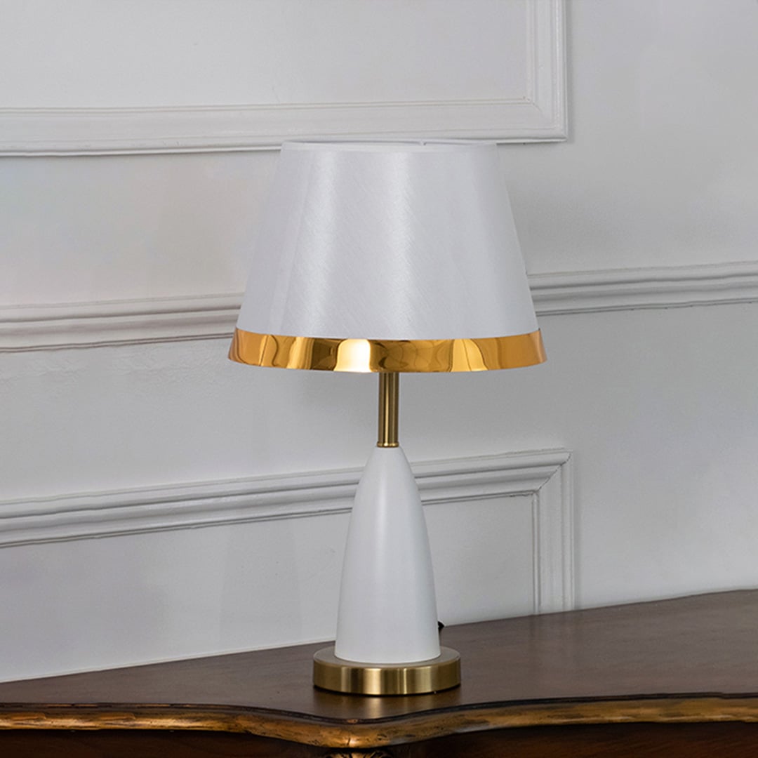 White and gold table lamp with fabric shade turned off on white background elegant bedside and living room table lamp.