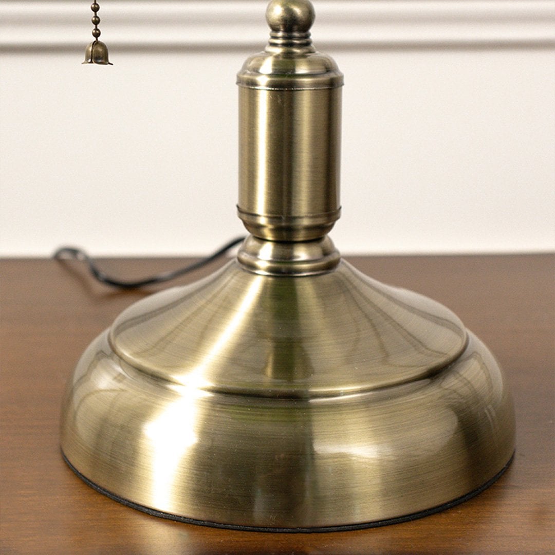 Detailed view of green glass shade and brass fittings of banker lamp showcasing premium craftsmanship and design.