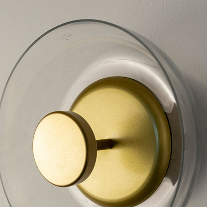 Focused shot of circular gold wall light revealing layered design and fine metallic finish for premium interiors.