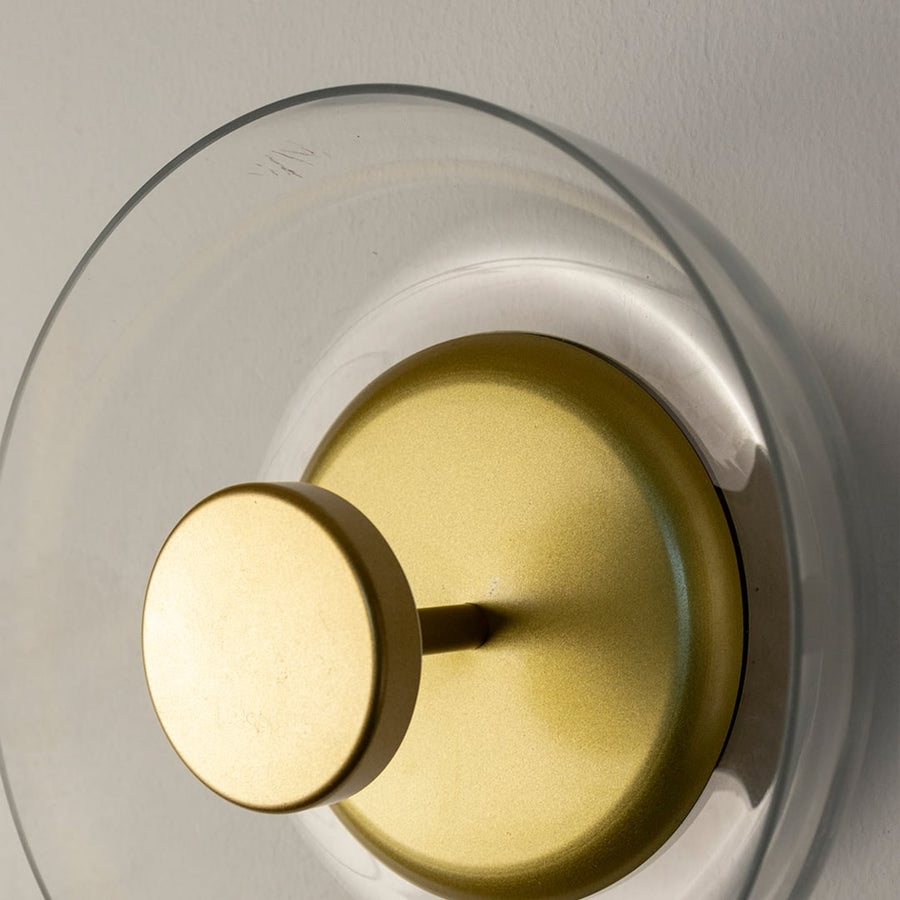 Focused shot of circular gold wall light revealing layered design and fine metallic finish for premium interiors.