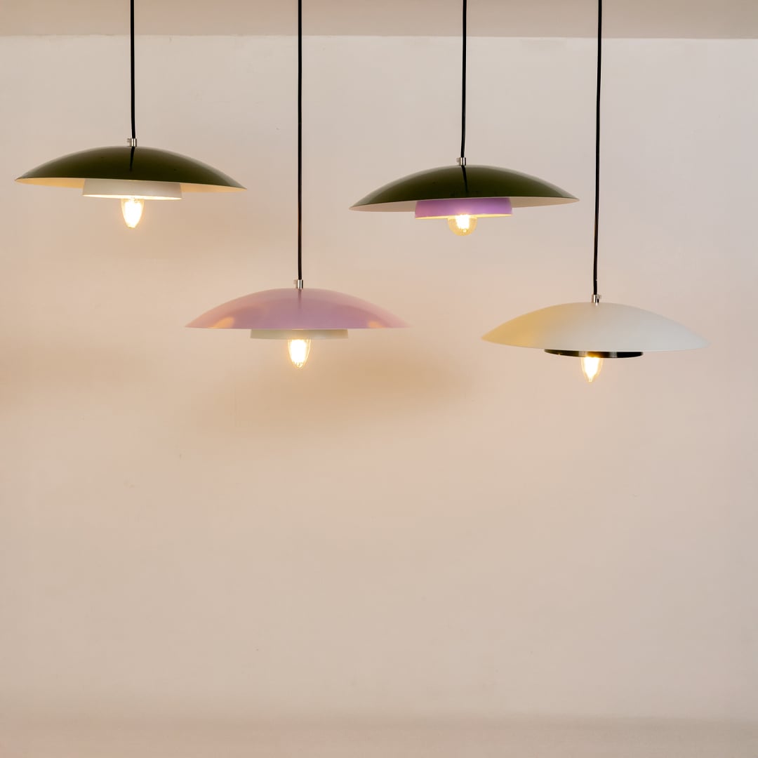 Green metal pendant lights grouped together to showcase modern kitchen dining and living room home decor styling.