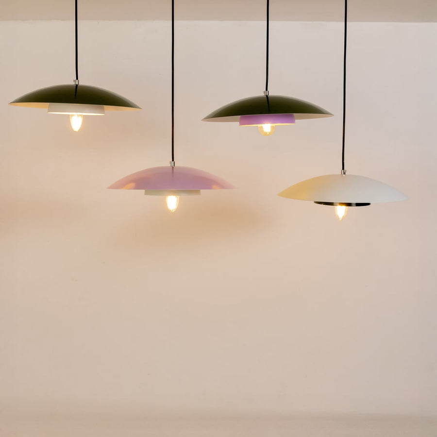 Green metal pendant lights grouped together to showcase modern kitchen dining and living room home decor styling.