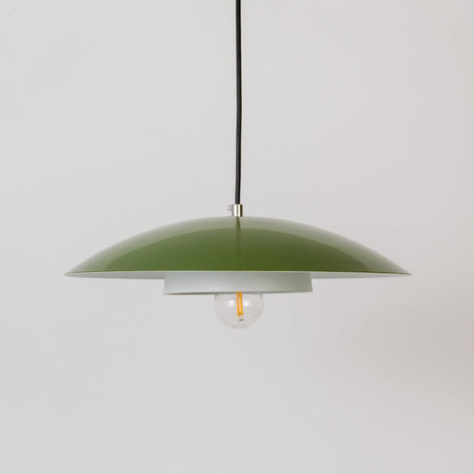 Green metal pendant light with bulb off shown on white background for modern kitchen dining and living room decor.