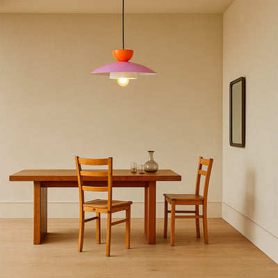 Colorful metal pendant light above dining table adding warm ambiance to modern interiors.