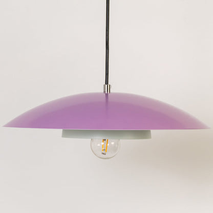 Closeup of lavender metal pendant light showing smooth dome and white inner plate for modern interior home decor.