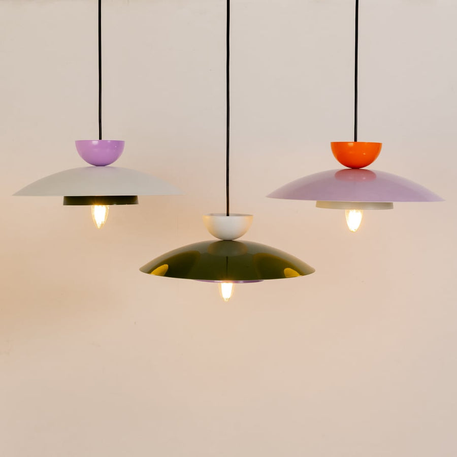 Multicolor metal pendant lights grouped together to showcase modern kitchen dining and living room home decor style.