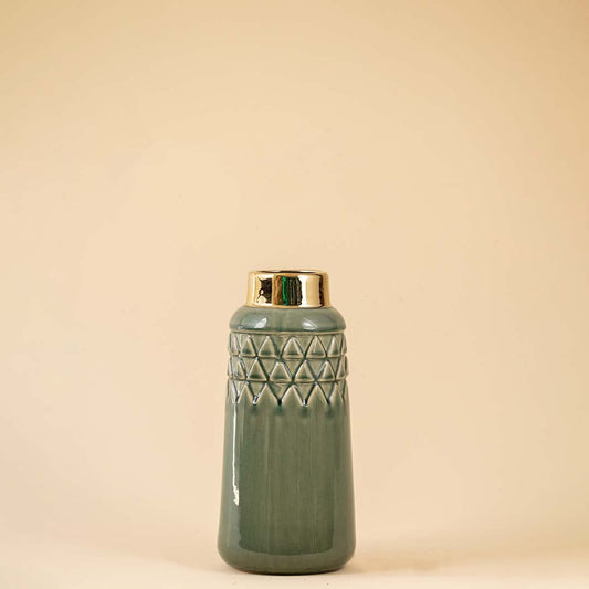 Stylish green ceramic vase with embossed triangular texture and shiny gold accent at the top placed on a white backdrop emphasizing its detailed craftsmanship.