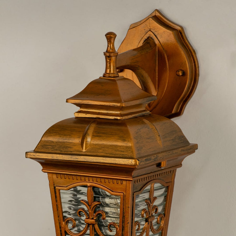 Closeup view of the gold outdoor lantern highlighting decorative glass details and textured metal design ideal for classic porch patio and entryway lighting.