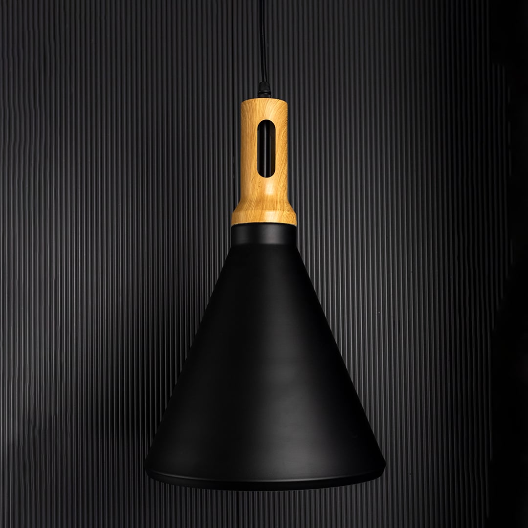 A modern black cone pendant lamp with wooden top glowing warmly on a dark background highlighting its soft ambient light and elegant minimal shape.