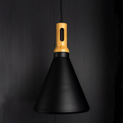 A modern black cone pendant lamp with wooden top glowing warmly on a dark background highlighting its soft ambient light and elegant minimal shape.