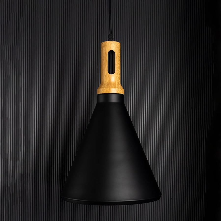 A modern black cone pendant lamp with wooden top glowing warmly on a dark background highlighting its soft ambient light and elegant minimal shape.