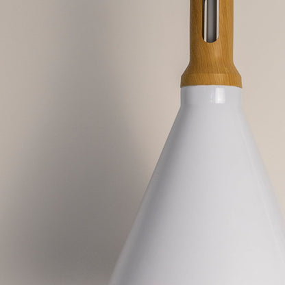Closeup of the pendant light highlighting the smooth white cone shade and natural wooden top capturing the clean finish and high quality material details.
