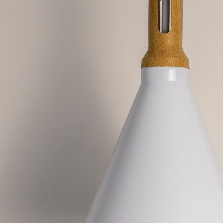 Closeup of the pendant light highlighting the smooth white cone shade and natural wooden top capturing the clean finish and high quality material details.