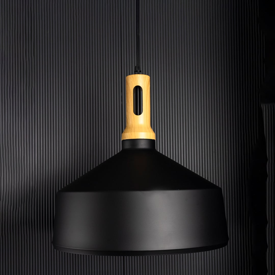 Minimal pendant light with matte black metal shade and gold accent displayed unlit on black background for modern ceiling styling.
