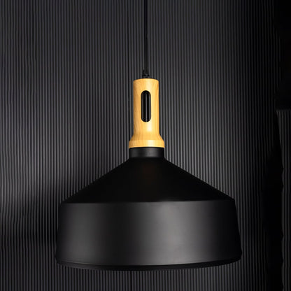 Minimal pendant light with matte black metal shade and gold accent displayed unlit on black background for modern ceiling styling.