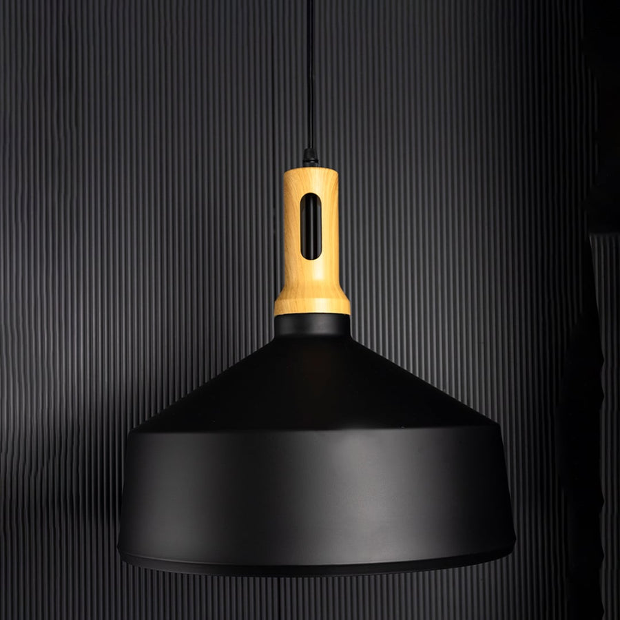 Minimal pendant light with matte black metal shade and gold accent displayed unlit on black background for modern ceiling styling.